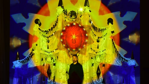 Artist, Ed Kluz stand in front of his installation Between Chaos and Light at Fountains Hall